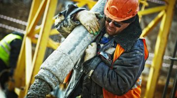 Construction worker pouring concrete.