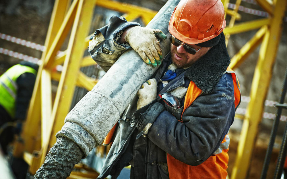 Construction worker pouring concrete.